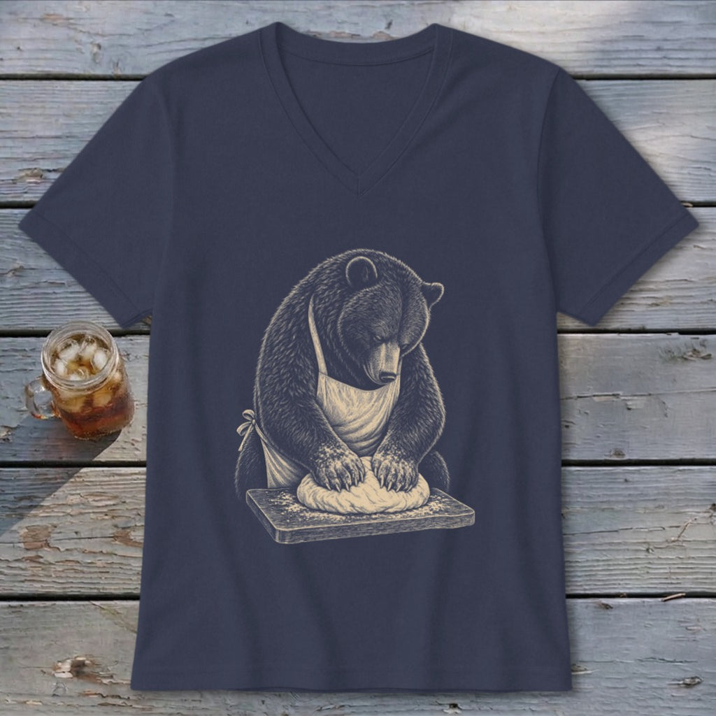 Bear in apron kneading dough on a wooden board, printed on a navy v-neck t-shirt.