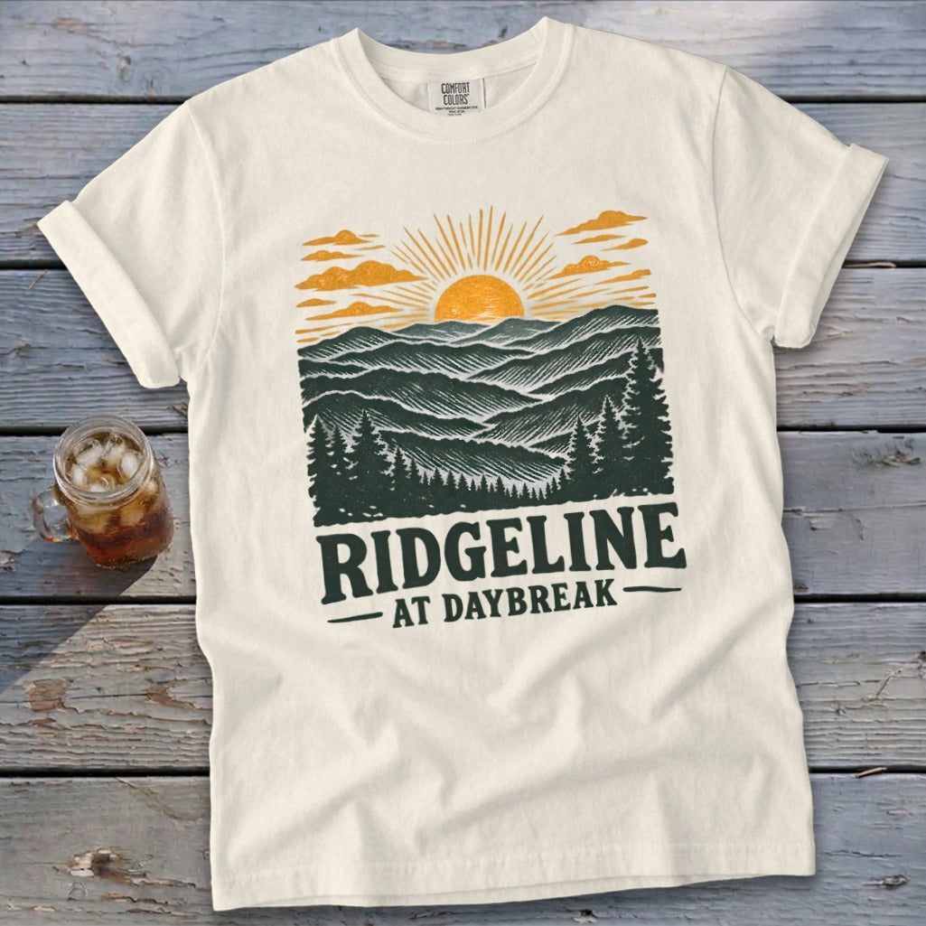 Cream t-shirt with "RIDGELINE AT DAYBREAK" landscape graphic.