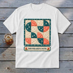 White t-shirt with a quilt square featuring "Drunkard's Path" pattern.