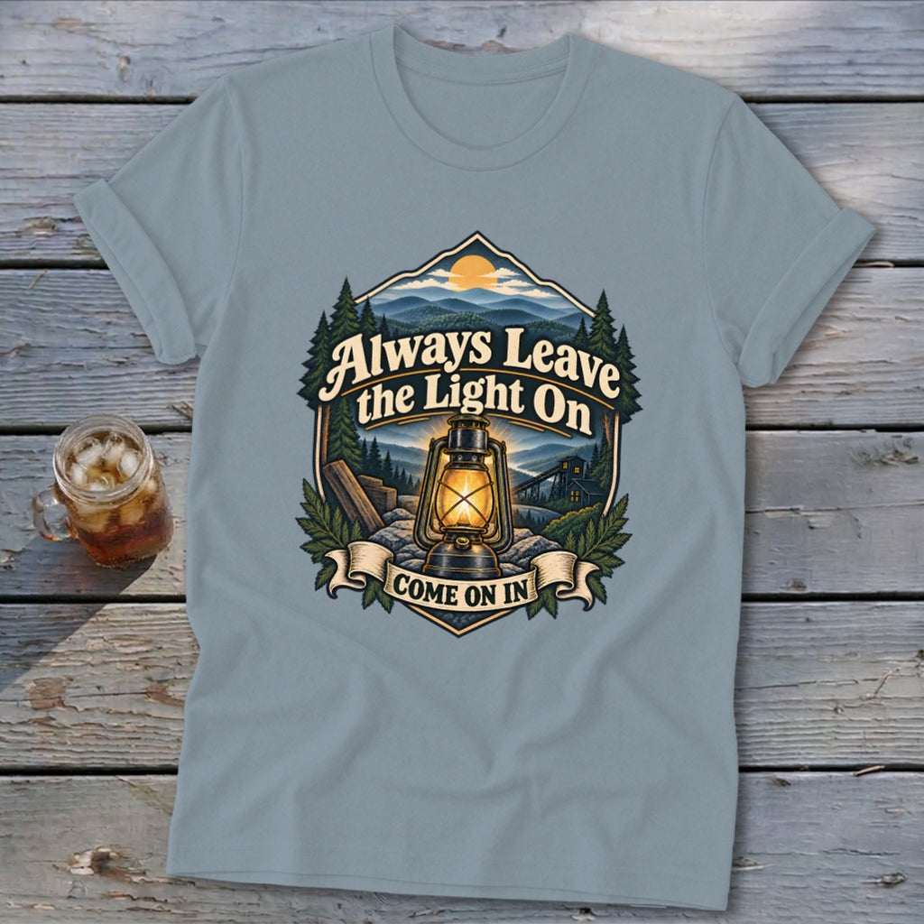T-shirt with vintage lantern and mountain graphic reading "Always Leave the Light On Come On In."