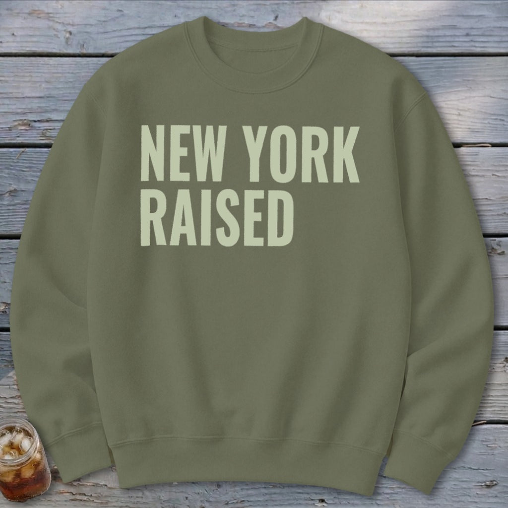 Olive green sweatshirt with "NEW YORK RAISED" text in light cream.