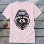Pink t-shirt with a black and white illustration of a raccoon wearing a beanie with mountains.