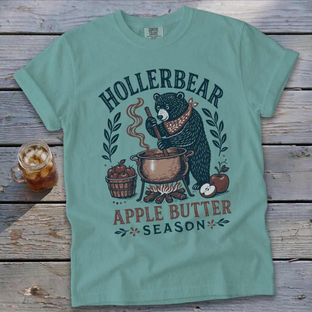Teal t-shirt with a bear making apple butter, text "HOLLERBEAR APPLE BUTTER SEASON".