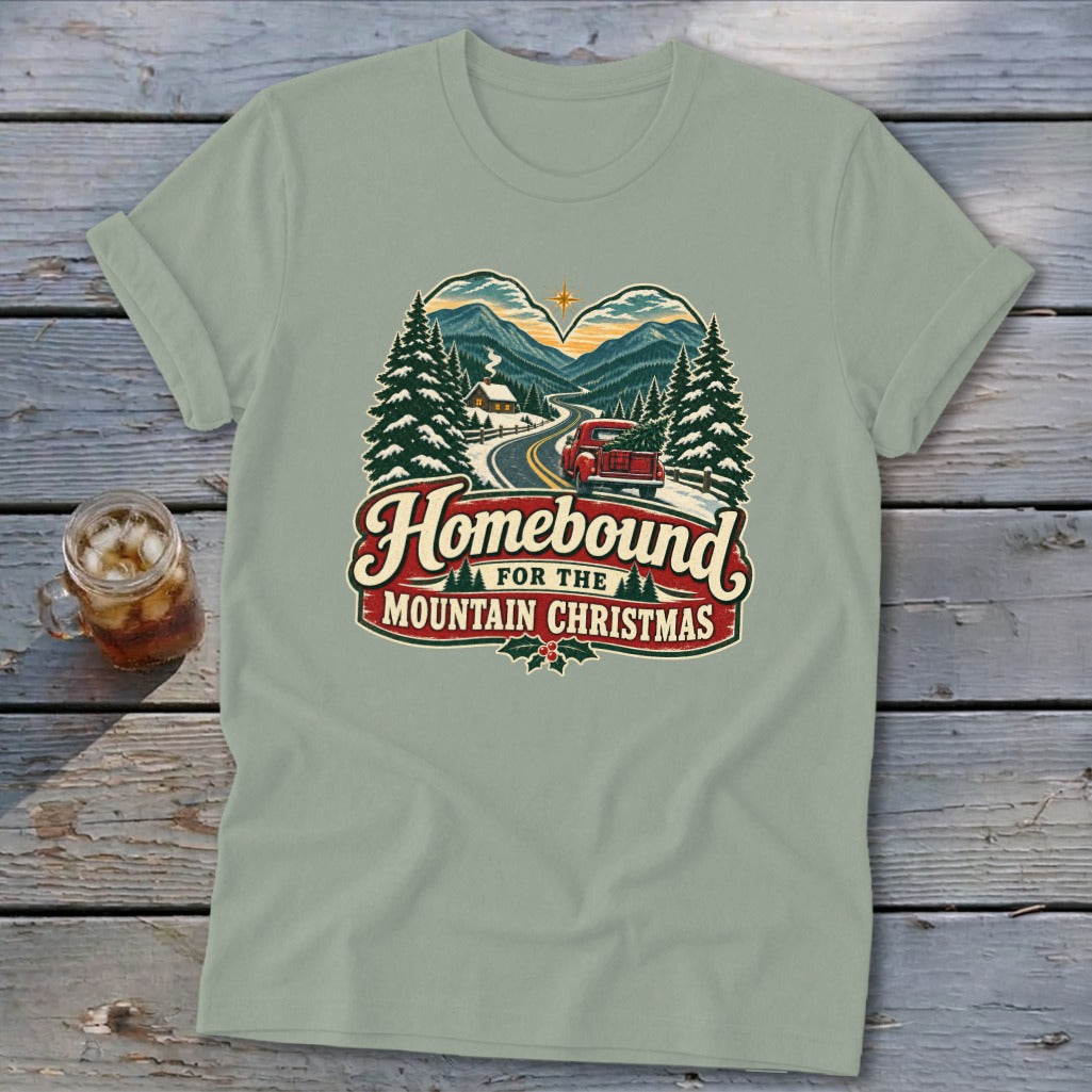 T-shirt graphic: red truck with Christmas tree, "Homebound for the Mountain Christmas".
