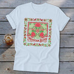 White t-shirt with red and green floral border and "Mountain Blood" text.