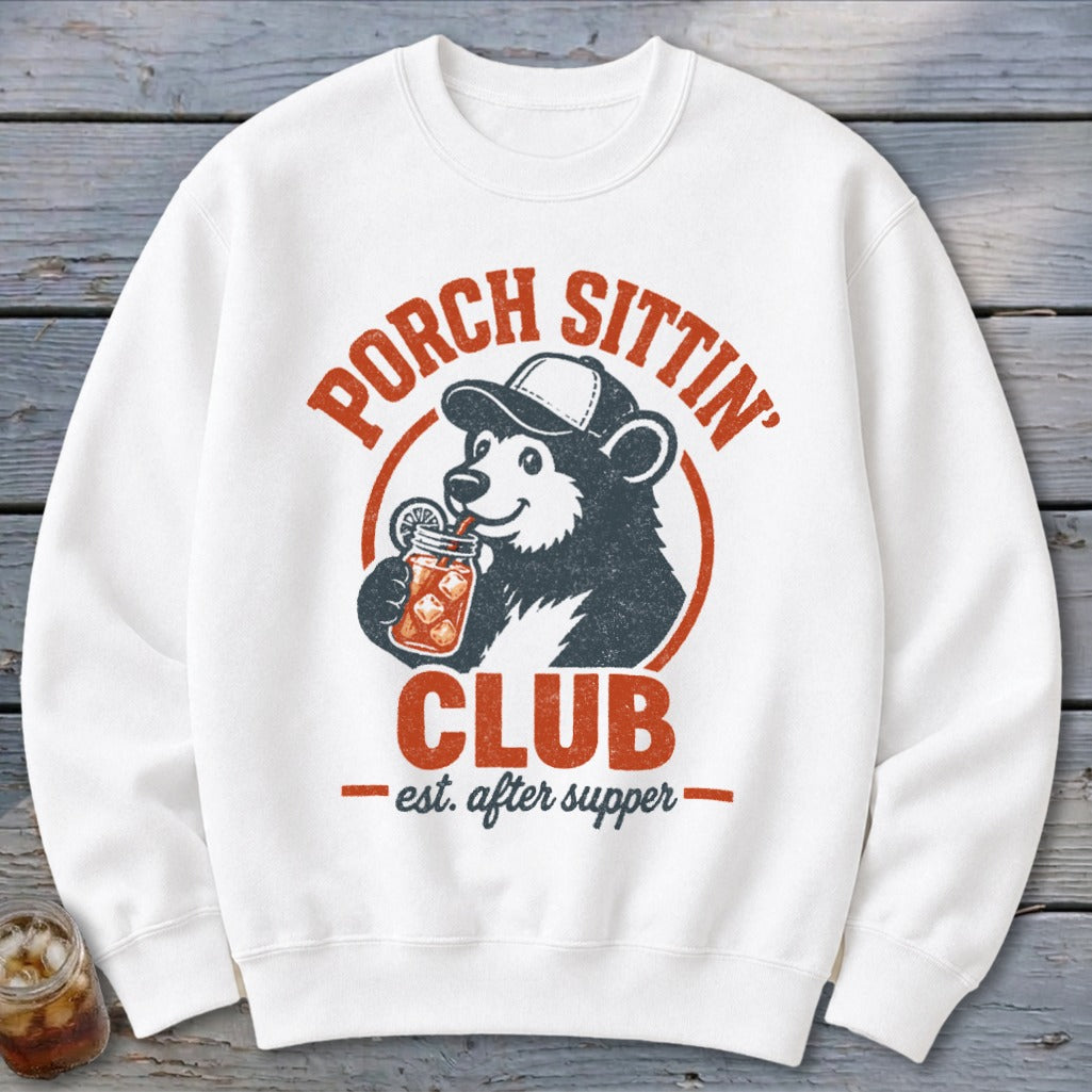 White sweatshirt with "Porch Sittin' Club est. after supper" graphic featuring a bear drinking from a mason jar.
