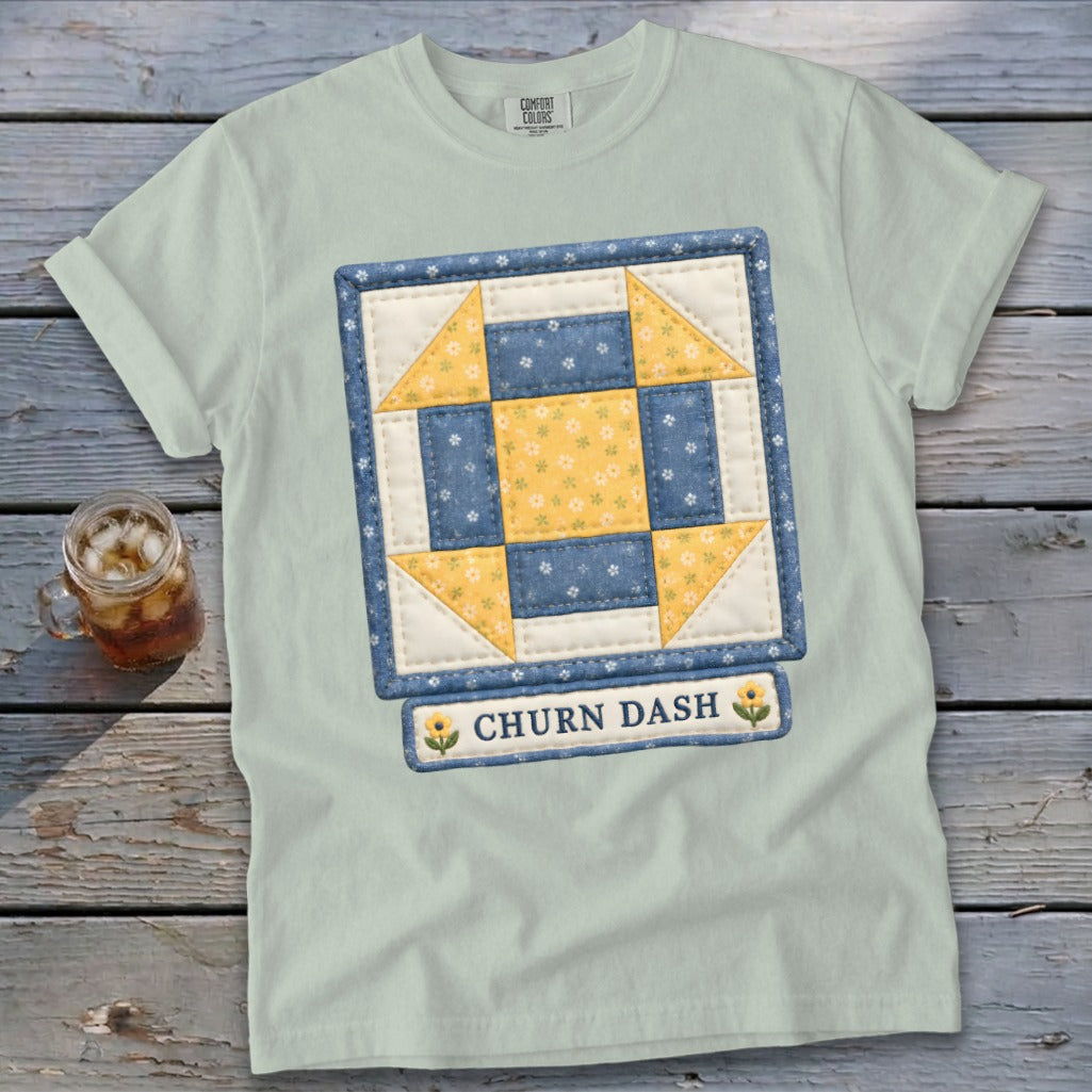 Light blue t-shirt with a Churn Dash quilt block graphic and text.