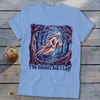 Light blue t-shirt with a ghost in a forest graphic that reads "The Haints Ain't Left".
