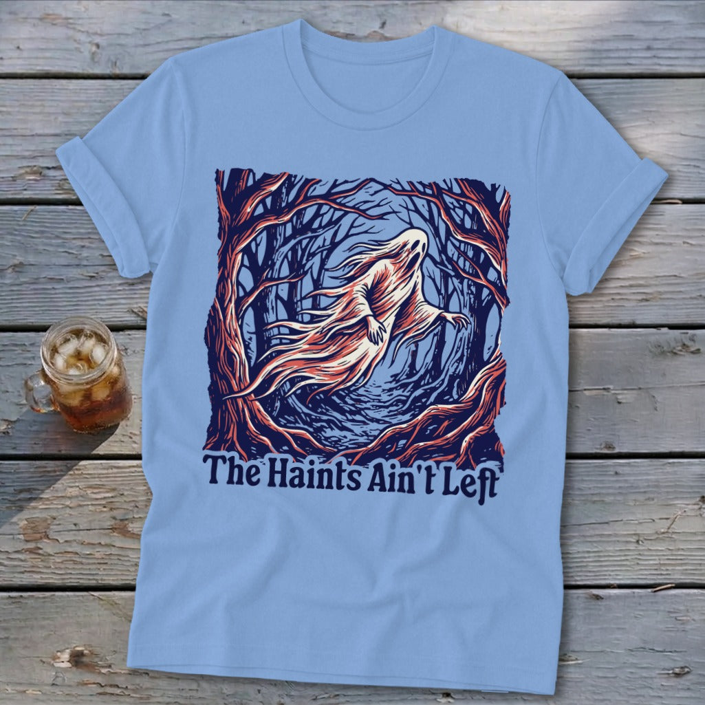 Light blue t-shirt with a ghost in a forest graphic that reads "The Haints Ain't Left".