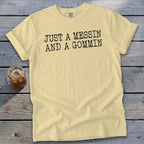 Yellow t-shirt with black text reading "JUST A MESSIN AND A GOMMIN".