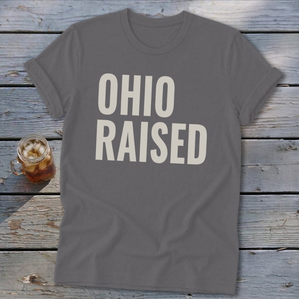Gray t-shirt with "OHIO RAISED" text in cream, next to a glass of iced tea.