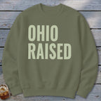 Olive green sweatshirt with light beige text reading "OHIO RAISED".