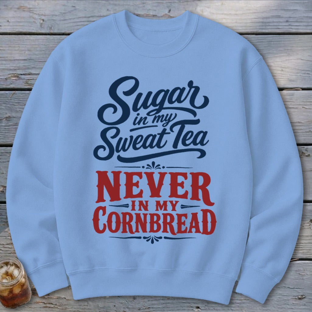 Light blue crewneck sweatshirt with dark blue and red text that reads Sugar in my Sweat Tea, Never in my Cornbread.