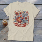 Beige t-shirt featuring a colorful graphic of an acoustic guitar, sunflowers, leaves, and the text MOUNTAIN MELODIES.