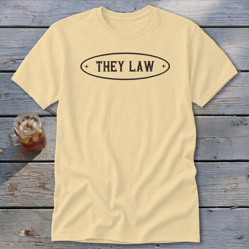 Pale yellow t-shirt with black text "THEY LAW" inside an oval.