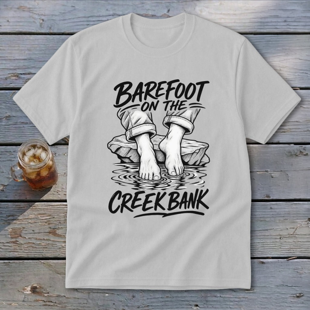 White t-shirt with illustration "Barefoot on the creek bank" and bare feet.