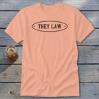Peach t-shirt with black oval text reading "THEY LAW"