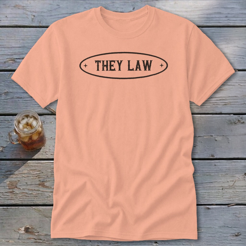 Peach t-shirt with black oval text reading "THEY LAW"