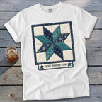 White t-shirt with an eight-pointed star quilt design and text.