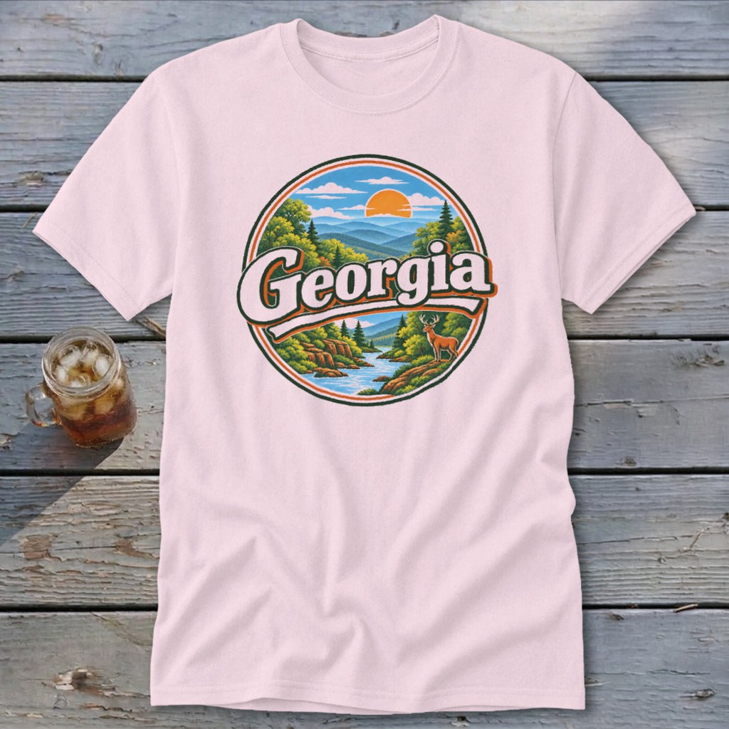 Pink t-shirt with a circular graphic featuring the word "Georgia" and a scenic mountain and river landscape.