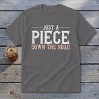 Gray t-shirt with "Just a Piece Down the Road" text.