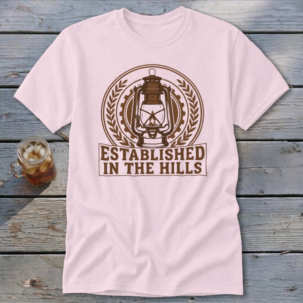 Light pink t-shirt with a brown lantern graphic and "ESTABLISHED IN THE HILLS" text.