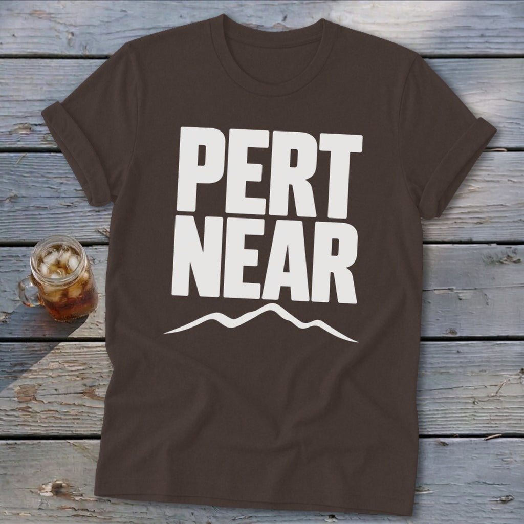 Brown crewneck t-shirt featuring bold white text that reads Pert Near above a mountain silhouette.