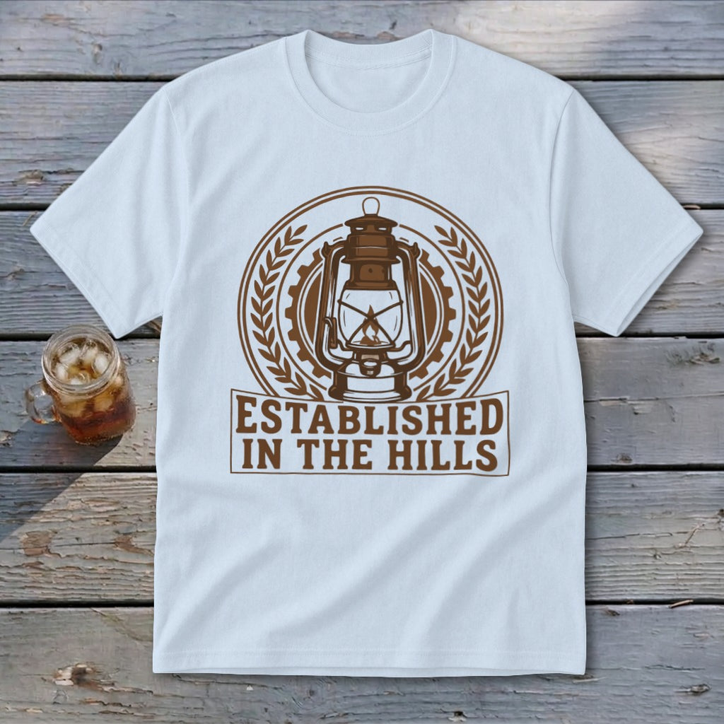 White t-shirt with brown graphic of a lantern and "Established In The Hills" text.