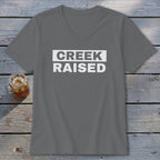 Grey v-neck t-shirt with "CREEK RAISED" in white text on a white rectangle.