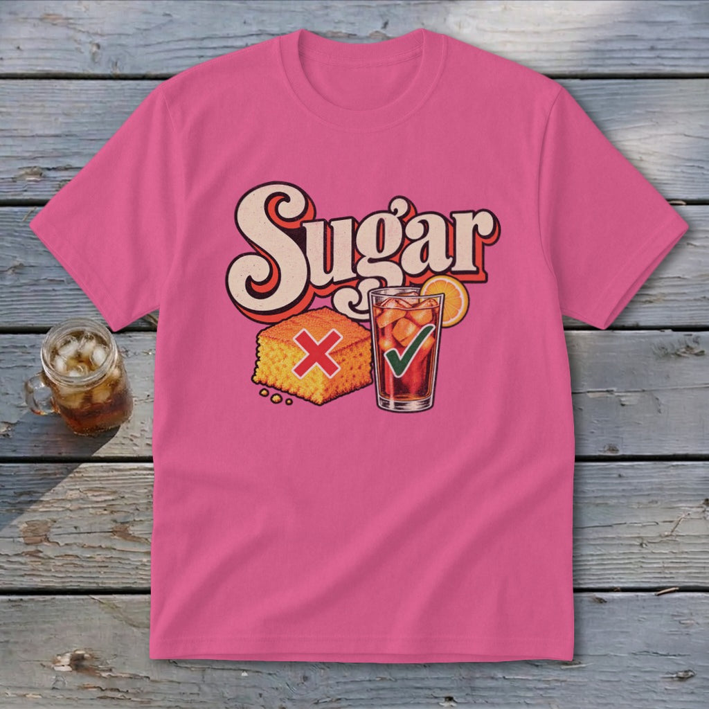 A pink t-shirt featuring a retro graphic with the text Sugar, a cornbread with a red X, and a glass of iced tea with a green checkmark.