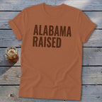 Orange t-shirt with "Alabama Raised" text in brown and a glass of iced tea.