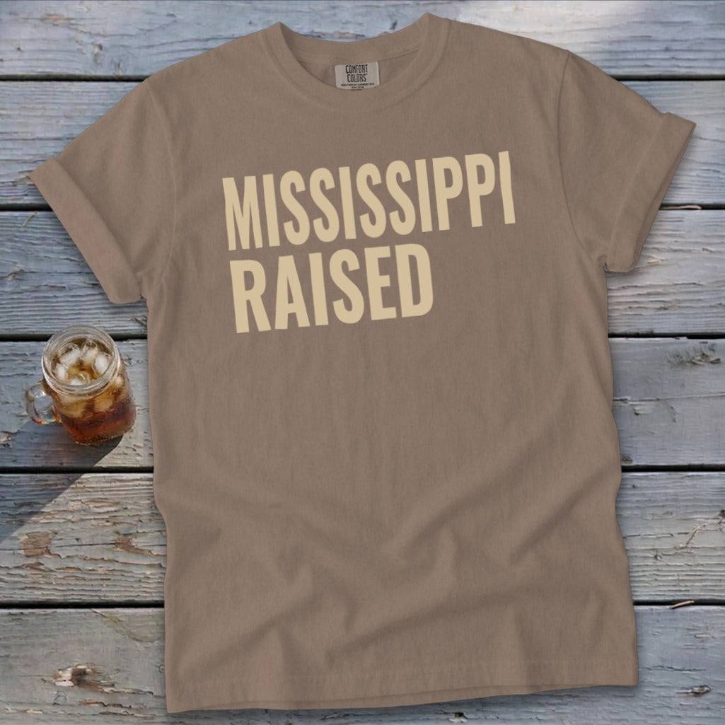Brown t-shirt with "MISSISSIPPI RAISED" text in beige.