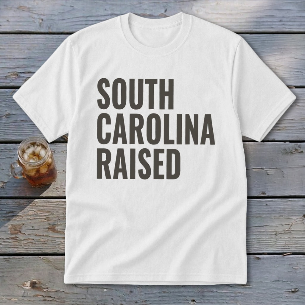 White t-shirt with "SOUTH CAROLINA RAISED" text in dark gray.