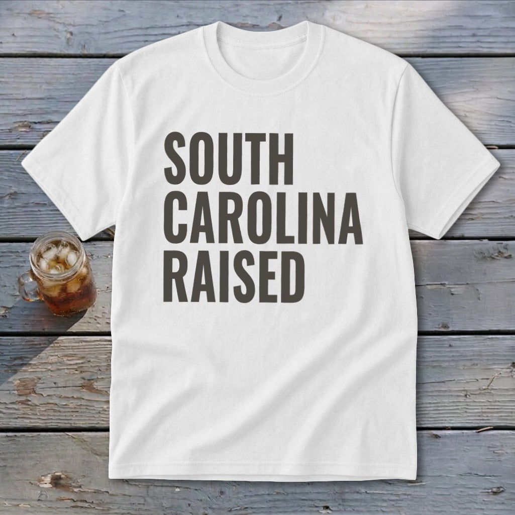 White t-shirt with "SOUTH CAROLINA RAISED" text in dark gray.