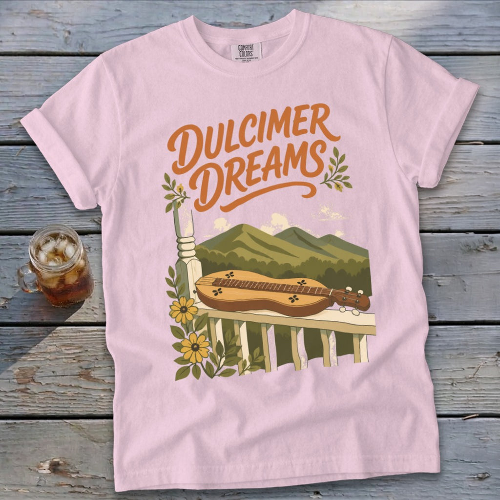 Pink t-shirt with "Dulcimer Dreams" text and a dulcimer on a porch railing.