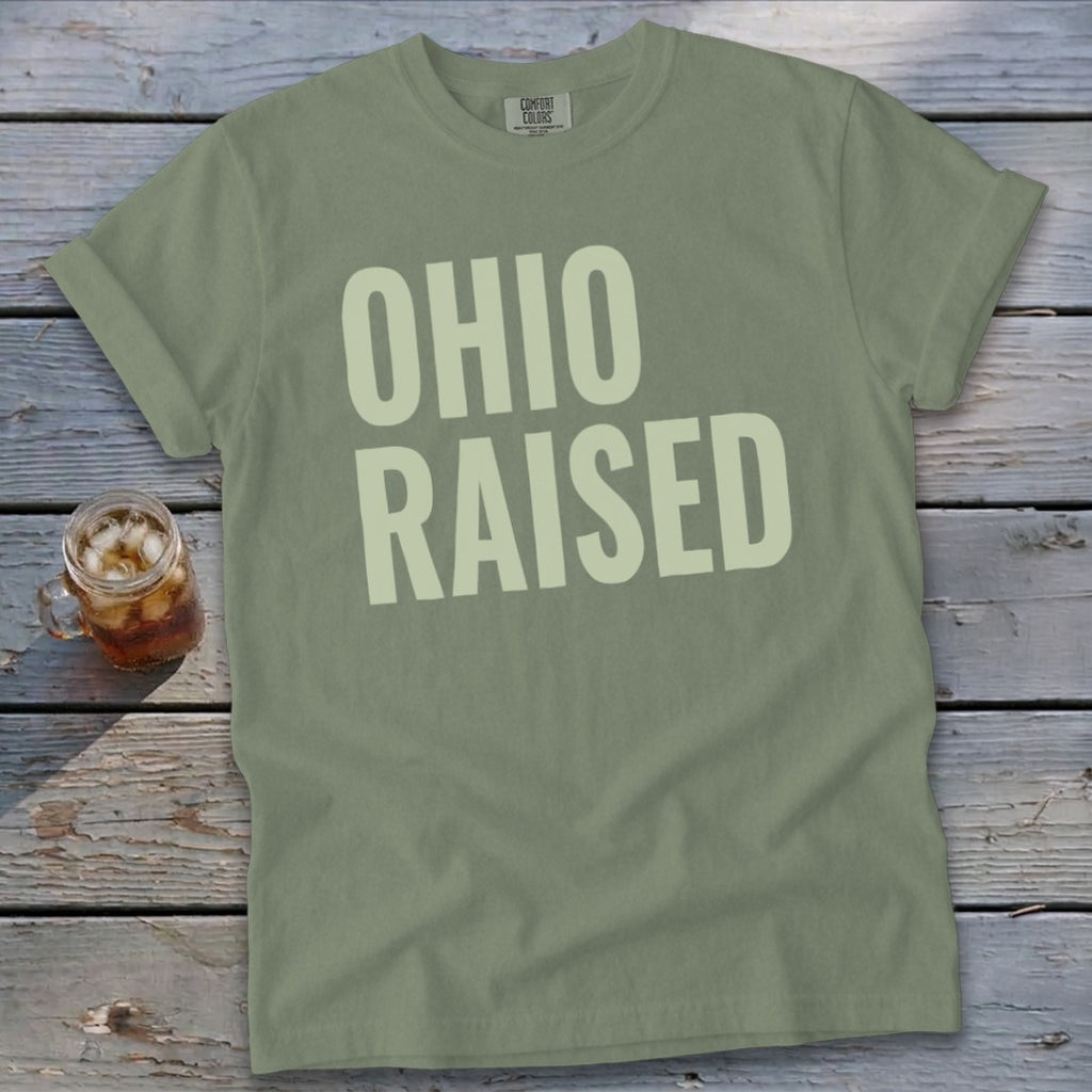 Green t-shirt with "OHIO RAISED" printed in large white letters.
