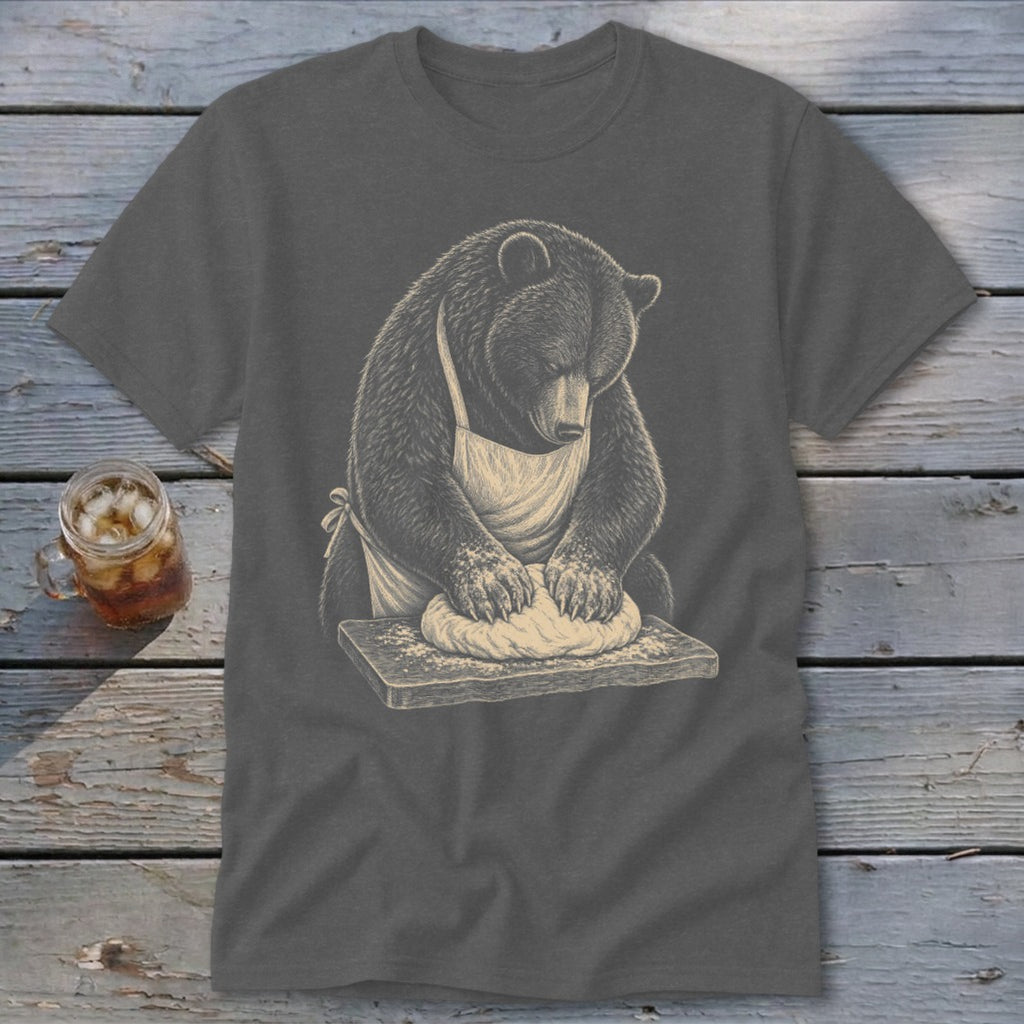 Bear wearing apron kneading dough on a wooden board.