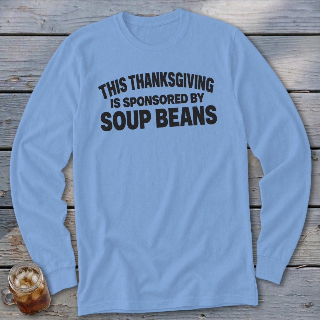 A light blue long-sleeved t-shirt with the black text "THIS THANKSGIVING IS SPONSORED BY SOUP BEANS."