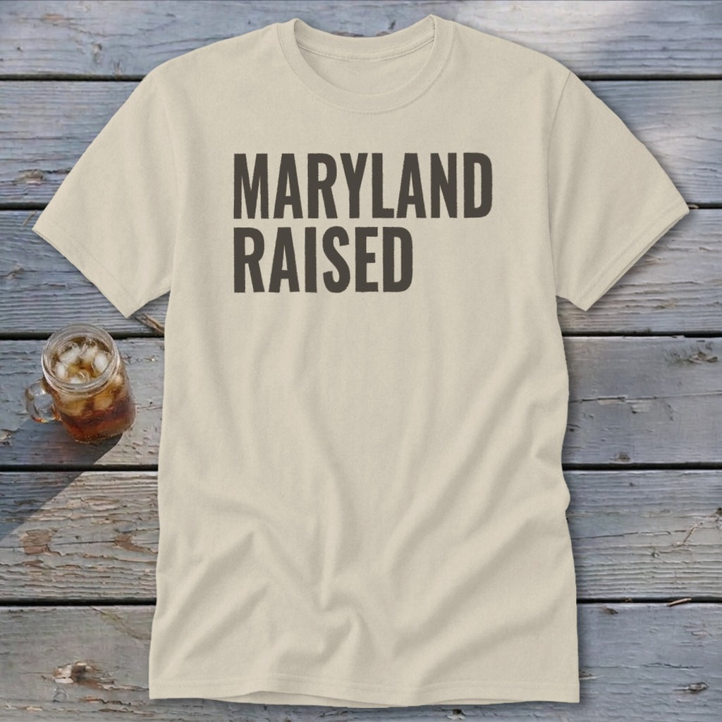 Light colored t-shirt with "MARYLAND RAISED" printed in dark text.