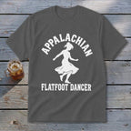 A dark gray t-shirt with a white graphic of a dancer and the text Appalachian Flatfoot Dancer.