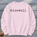 Light pink crewneck sweatshirt with "mizewell" in black typewriter font.