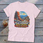 T-shirt graphic with autumn mountain scenery and text: Peak weekend. Same playlist. New overlook.