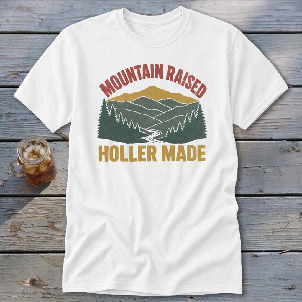 White t-shirt featuring a retro mountain graphic with the text "MOUNTAIN RAISED HOLLER MADE."