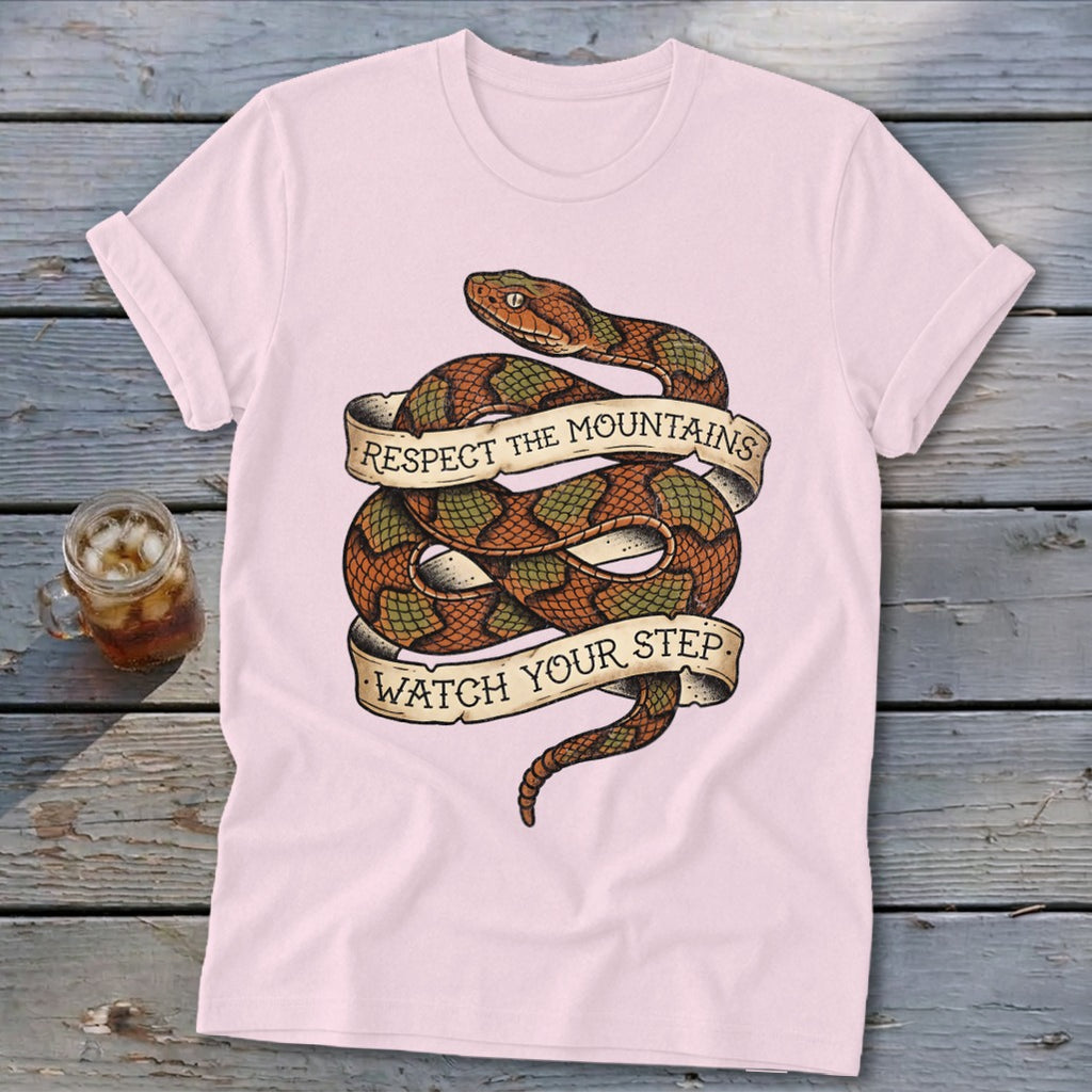 Pink t-shirt with coiled snake graphic reading "Respect the Mountains Watch Your Step".