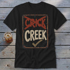 Black t-shirt with distressed "CRICK CREEK" sign graphic and checkmark.
