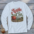 White long-sleeve t-shirt featuring a graphic of an apple on a wooden post with mountains and a cabin.