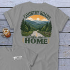 Grey t-shirt with "Country Roads Take Me Home" graphic of a mountain road at sunset.