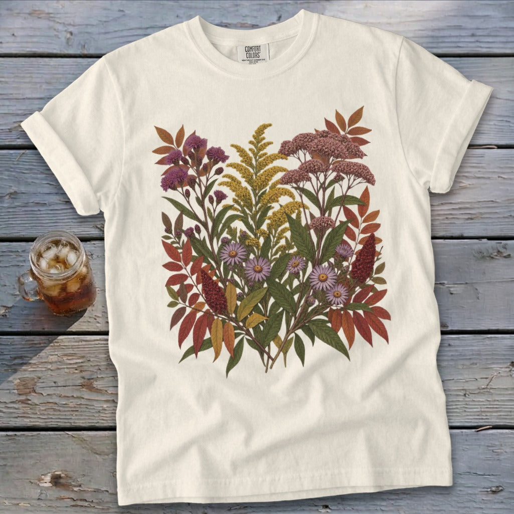 Cream t-shirt with a detailed floral print of wildflowers and fall leaves.