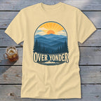Cream t-shirt featuring a retro graphic of mountains, trees, a sun, and Over Yonder text.