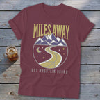 Maroon t-shirt with "Miles Away But Mountain Bound" graphic.